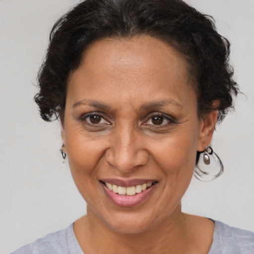 Joyful latino adult female with short  brown hair and brown eyes