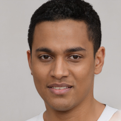 Joyful latino young-adult male with short  black hair and brown eyes