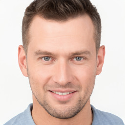 Joyful white young-adult male with short  brown hair and brown eyes