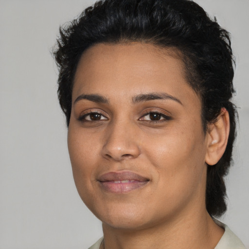 Joyful latino young-adult female with short  black hair and brown eyes