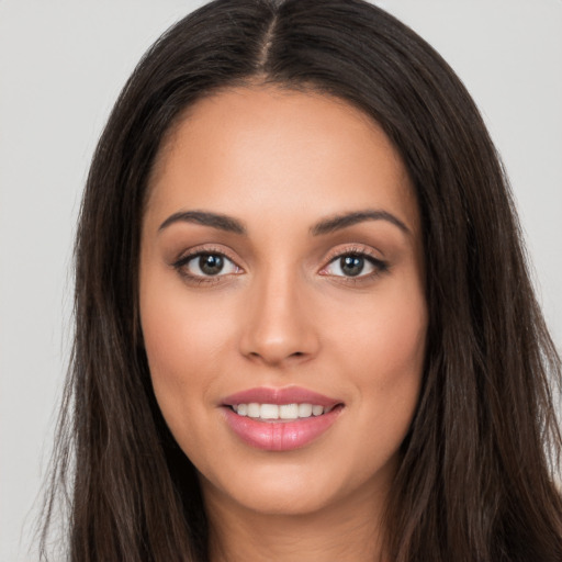 Joyful white young-adult female with long  brown hair and brown eyes