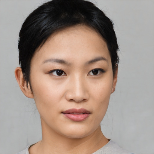 Joyful asian young-adult female with short  black hair and brown eyes