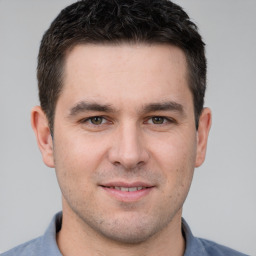 Joyful white young-adult male with short  brown hair and brown eyes