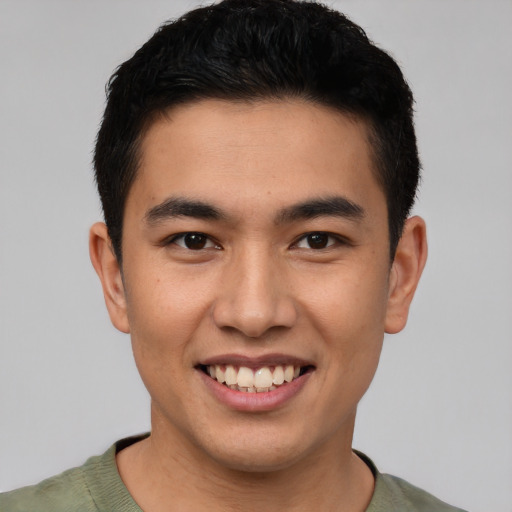 Joyful latino young-adult male with short  brown hair and brown eyes