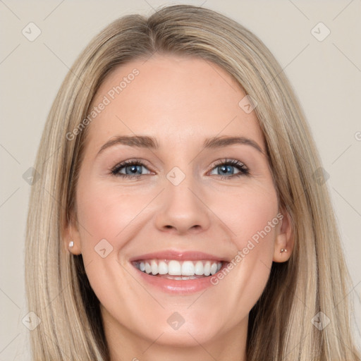 Joyful white young-adult female with long  brown hair and blue eyes