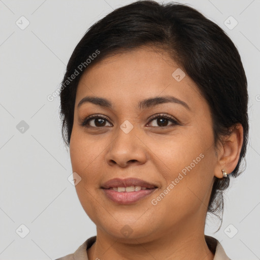 Joyful latino young-adult female with medium  brown hair and brown eyes