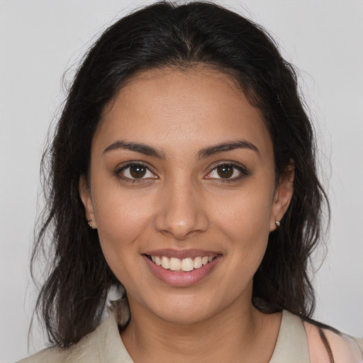 Joyful latino young-adult female with medium  brown hair and brown eyes