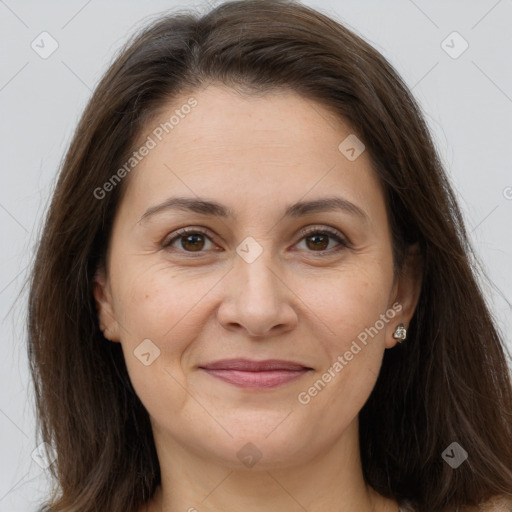 Joyful white adult female with long  brown hair and brown eyes