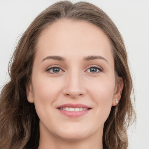 Joyful white young-adult female with long  brown hair and grey eyes