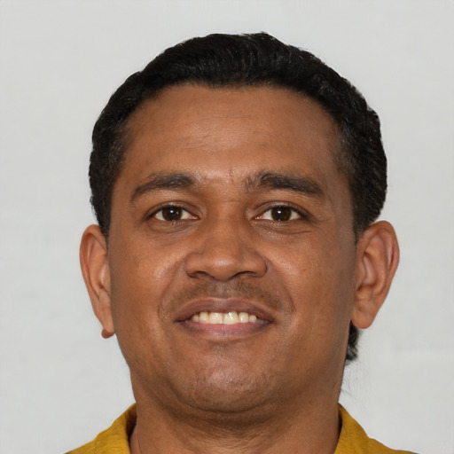 Joyful latino adult male with short  black hair and brown eyes