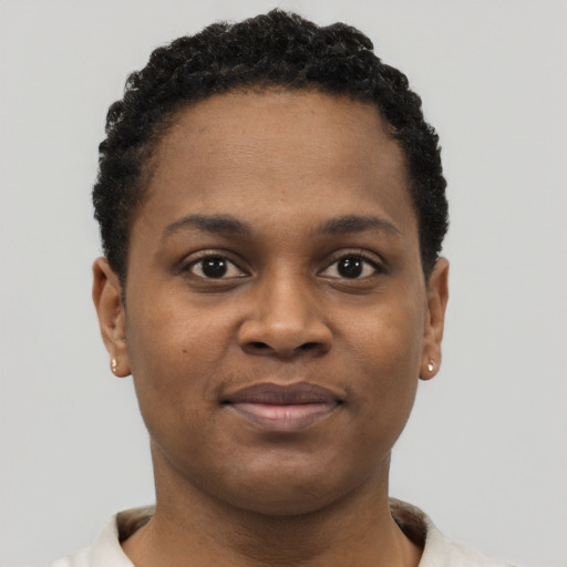 Joyful black young-adult female with short  brown hair and brown eyes