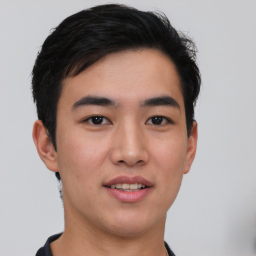 Joyful asian young-adult male with short  black hair and brown eyes