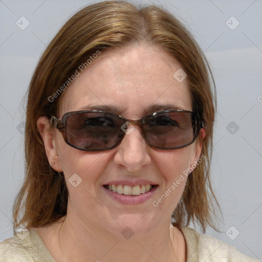 Joyful white adult female with medium  brown hair and blue eyes