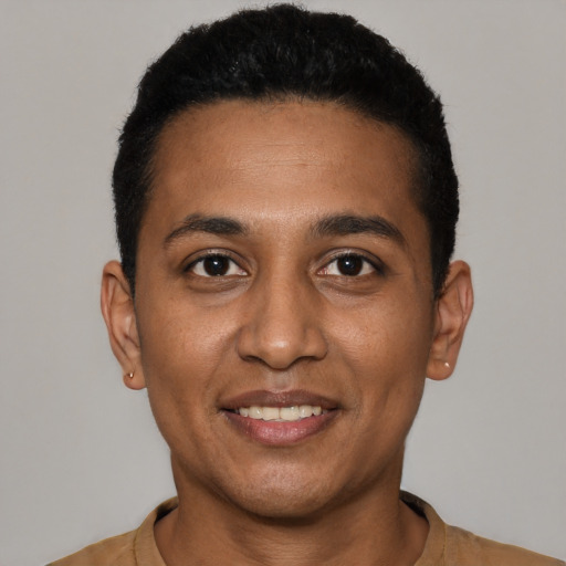 Joyful black young-adult male with short  black hair and brown eyes