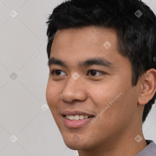 Joyful asian young-adult male with short  black hair and brown eyes