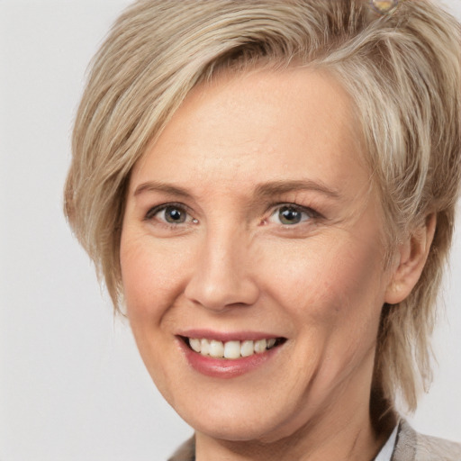 Joyful white adult female with medium  brown hair and grey eyes