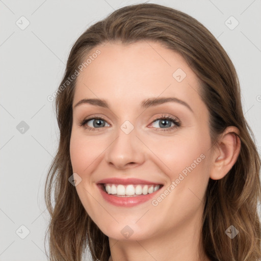 Joyful white young-adult female with long  brown hair and blue eyes