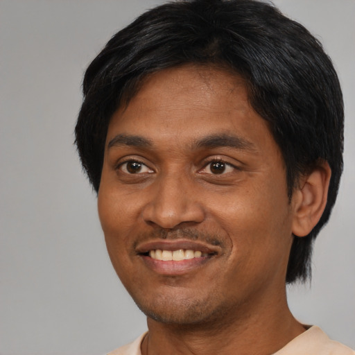 Joyful asian adult male with short  black hair and brown eyes