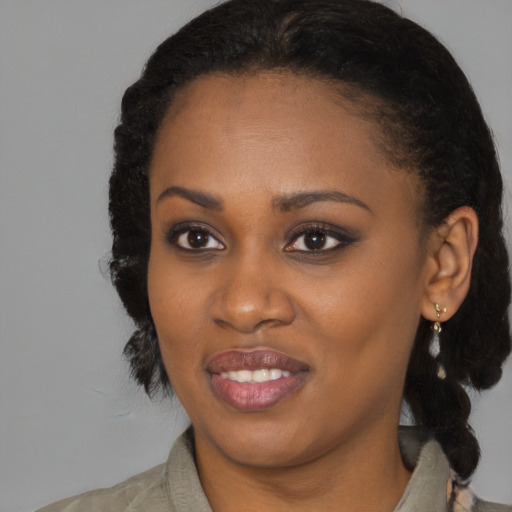 Joyful black young-adult female with medium  black hair and brown eyes