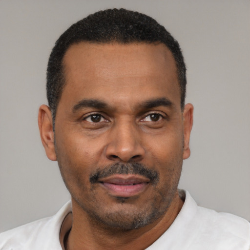 Joyful latino adult male with short  black hair and brown eyes