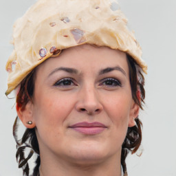 Joyful white adult female with medium  brown hair and grey eyes