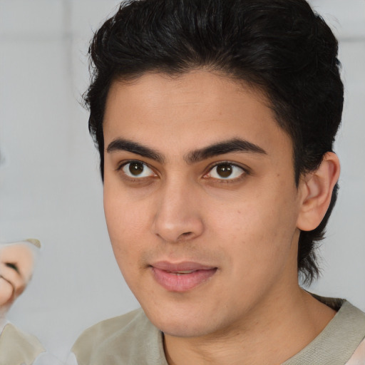 Joyful asian young-adult male with short  brown hair and brown eyes