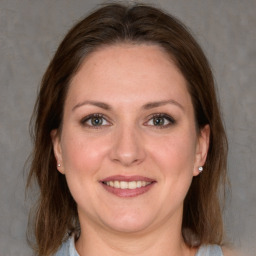 Joyful white adult female with medium  brown hair and grey eyes