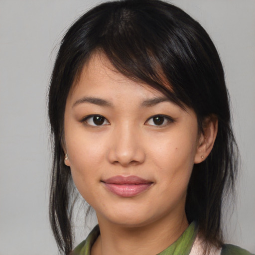 Joyful asian young-adult female with medium  brown hair and brown eyes