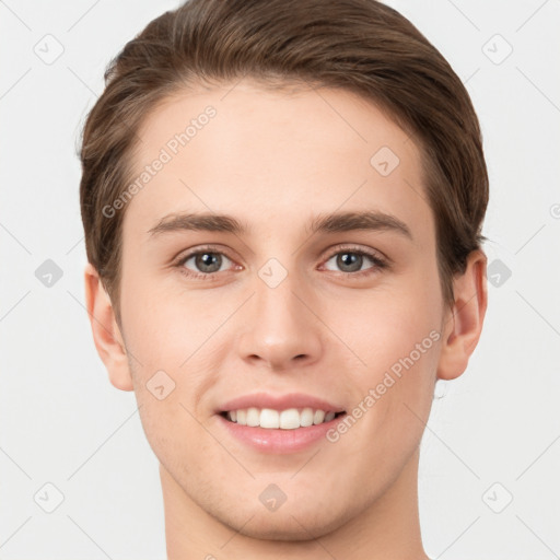 Joyful white young-adult male with short  brown hair and grey eyes