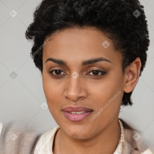 Joyful black young-adult female with short  brown hair and brown eyes