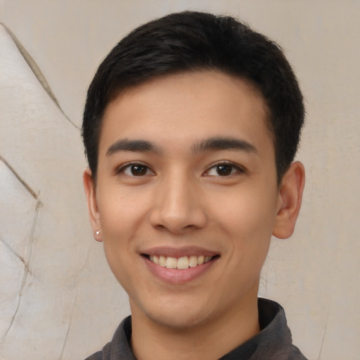 Joyful latino young-adult male with short  brown hair and brown eyes