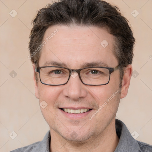 Joyful white adult male with short  brown hair and grey eyes