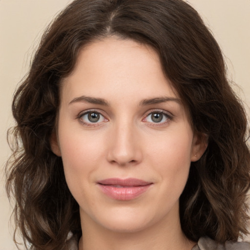 Joyful white young-adult female with medium  brown hair and green eyes