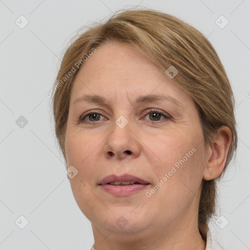 Joyful white adult female with medium  brown hair and grey eyes