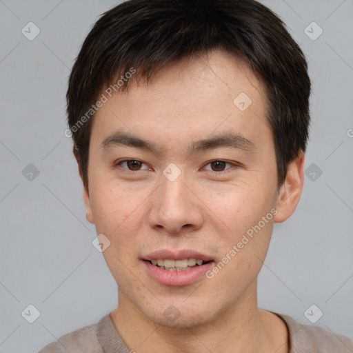 Joyful asian young-adult male with short  brown hair and brown eyes