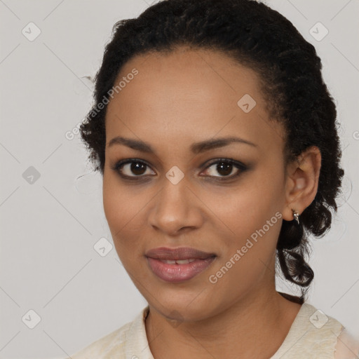 Joyful black young-adult female with long  black hair and brown eyes