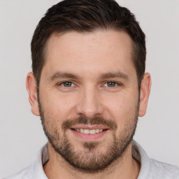 Joyful white young-adult male with short  brown hair and brown eyes