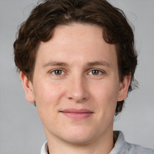 Joyful white adult male with short  brown hair and grey eyes