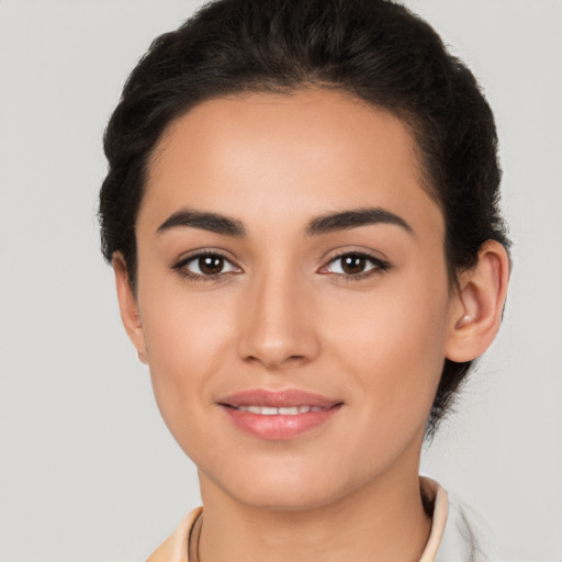 Joyful latino young-adult female with short  brown hair and brown eyes