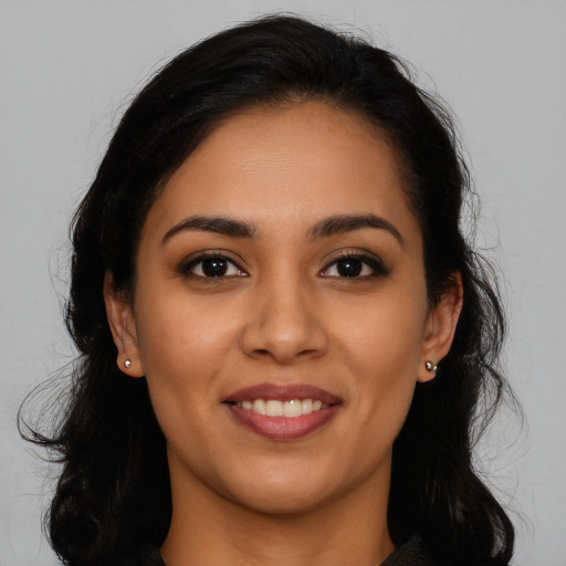 Joyful latino young-adult female with long  brown hair and brown eyes