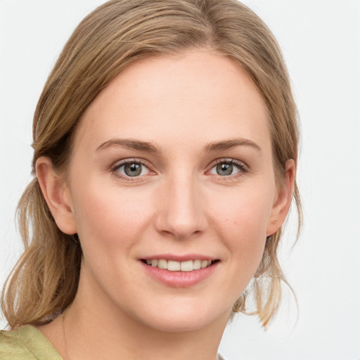 Joyful white young-adult female with medium  brown hair and blue eyes