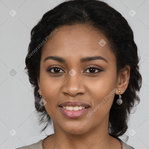 Joyful black young-adult female with long  black hair and brown eyes