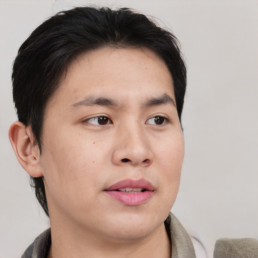 Joyful asian young-adult male with short  brown hair and brown eyes