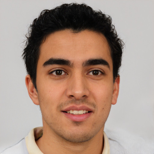 Joyful latino young-adult male with short  brown hair and brown eyes