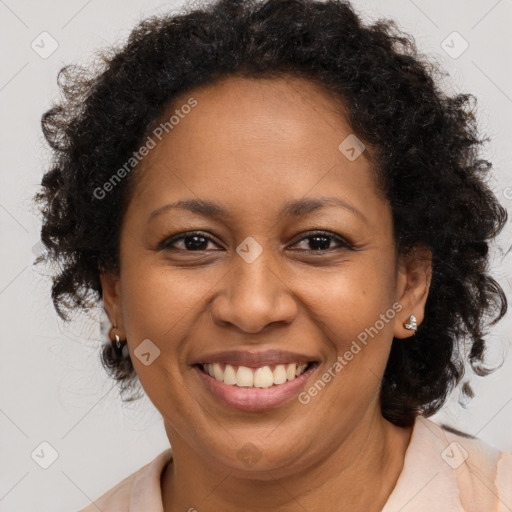 Joyful black adult female with medium  brown hair and brown eyes