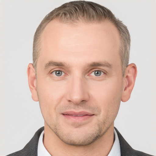 Joyful white adult male with short  brown hair and grey eyes