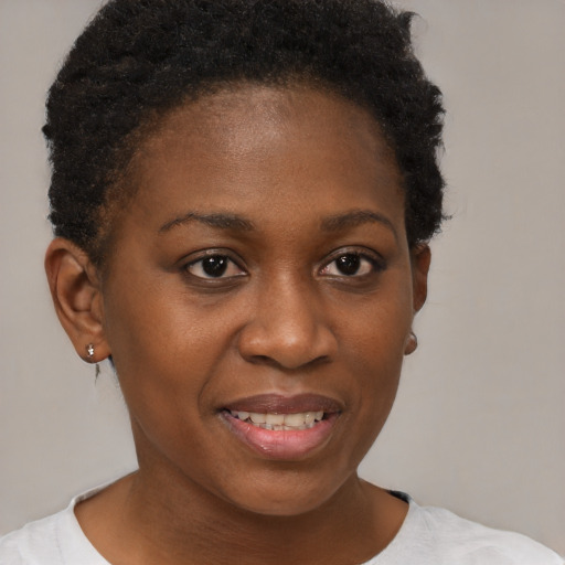 Joyful black young-adult female with short  brown hair and brown eyes