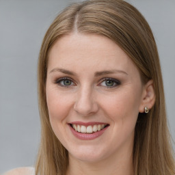 Joyful white young-adult female with long  brown hair and green eyes