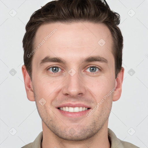 Joyful white young-adult male with short  brown hair and grey eyes