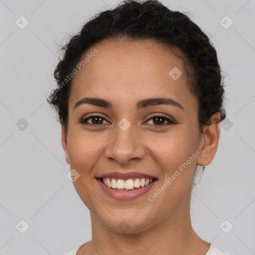 Joyful latino young-adult female with short  brown hair and brown eyes